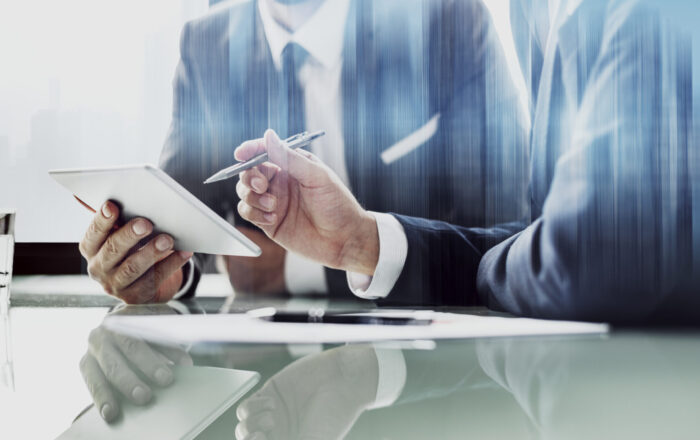 Corporate businessmen working on tablet at office